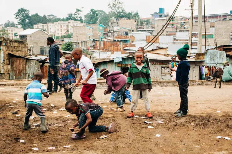 Children playing in a dusty urban street