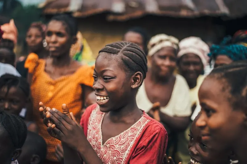 Young Rwandan women laughing together in their community