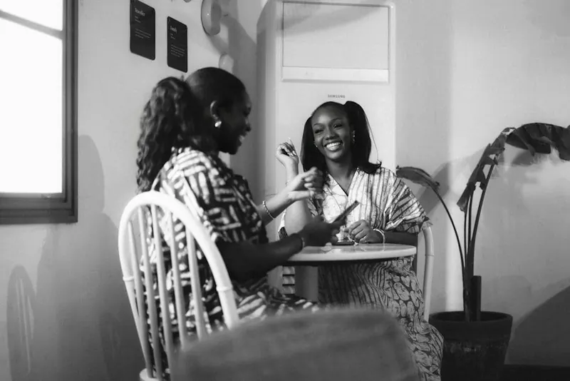 Two women in warm conversation at a table